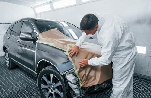 Covering,Car,By,Brown,Cloth.,Caucasian,Automobile,Repairman,In,Uniform
